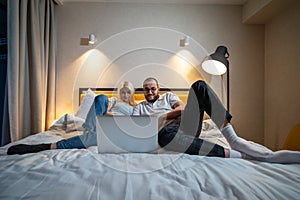 Couple Sharing Laptop Time in Bedroom