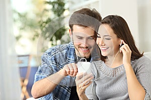 Couple sharing music from smart phone