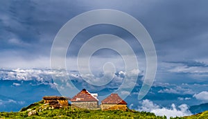 A couple of shephard huts on edge of a mountain