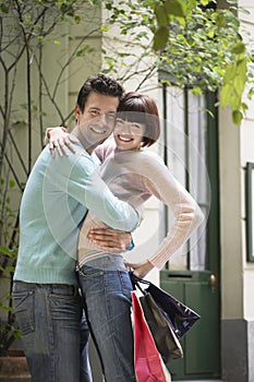 Couple With Shopping Bags Embracing