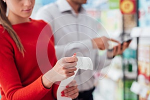 Couple shopping and checking a receipt