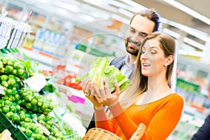 Couple shopping groceries in supermarket