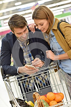 Couple shopping for groceries in supermarket