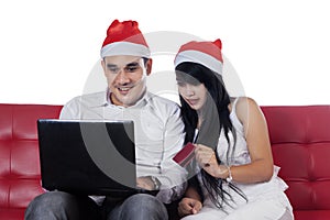 Couple shopping online for christmas day