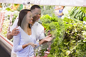 Couple shopping in produce department