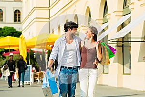 Couple shopping and spending money in city