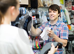 Couple shops at store buying socks