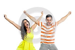 Couple shouting with arms raised.