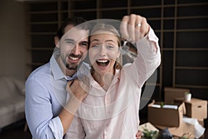 Couple showing bunch of keys from their new first house