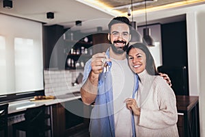 Couple showing keys to new home