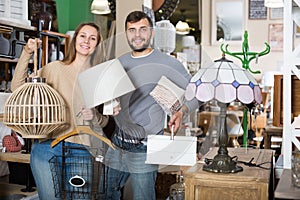 couple showing with purchases in furnishings store