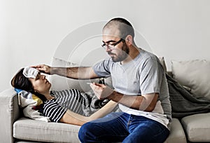 Couple sick at home on the sofa