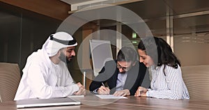 Couple signing agreement and shake hands Arabian advisor