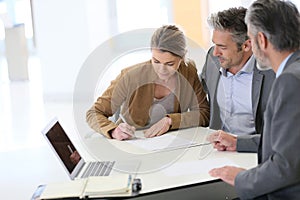 Couple signing contract in bank