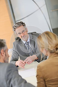 Couple signing contract at lawyer's