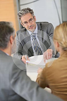 Couple signing contract at lawyer's office