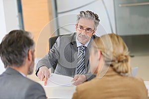 Couple signing contract in lawyer's office