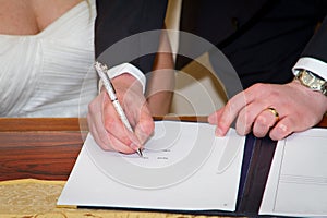 Couple signing marriage registration form