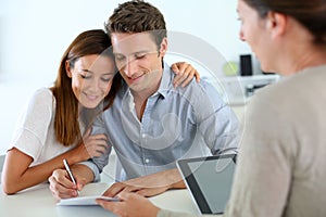 Couple signing real-estate contract