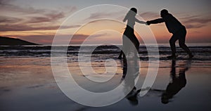 Couple, silhouette and dancing on beach for bonding, water splash or fun outdoor evening together. Man and woman