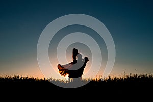 Couple silhouette dancing in the sunset