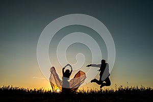 Couple silhouette dancing in the sunset
