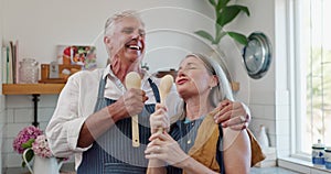 Couple, singing or laughing in kitchen, house or home while bonding and cooking lunch on holiday. Pensioners, joking and