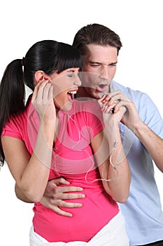 Couple singing and listening music