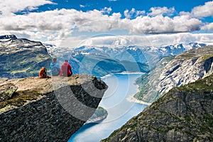 Couple sitting against amazing nature view on the way to Trolltunga. Location: Scandinavian