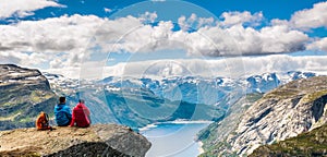 Couple sitting against amazing nature view on the way to Trolltunga. Location: Scandinavian