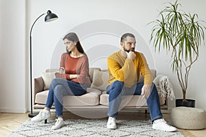 Couple sitting apart with tension