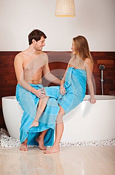 Couple sitting on bathtub