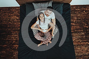 Man is Touching Belly of Pregnant Woman on Bed