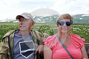 Couple sitting on bench on Lago-Naki plateau