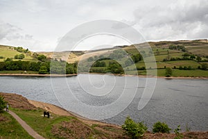 Couple sitting on a bench looking out at Ladybower Reservoir