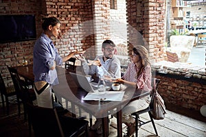 Couple sitting in cafe, arguing with waitress. issue, conflict, problem concept