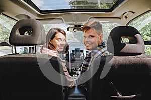 couple sitting in car driving to travel destination