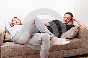 Couple sitting on the couch after a dispute