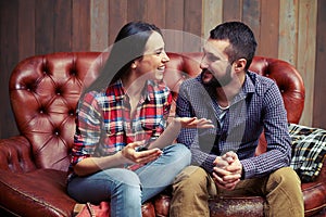 Couple sitting on couch and have a nice conversation