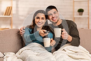 Couple sitting on couch and watching TV