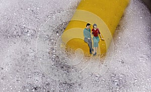 Couple sitting on the dock by a dishwasher sponge