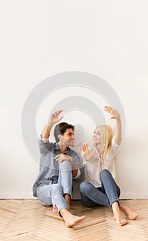 Couple Sitting On Floor Sharing Interior Design Ideas For Home