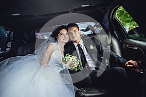 The couple sitting in the limo. Portrait of a beautiful young couple who rides around the city