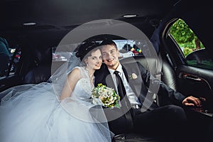 The couple sitting in the limo. Portrait of a beautiful young couple who rides around the city