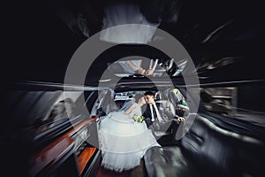 The couple sitting in the limo. Portrait of a beautiful young couple who rides around the city. Concept of movement