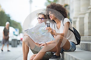 Couple sitting in monument sightseeing sharing map