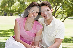 Couple sitting outdoors smiling