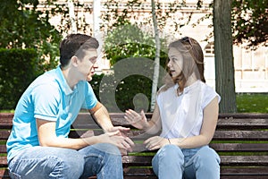 Couple sitting in park having relationship problems