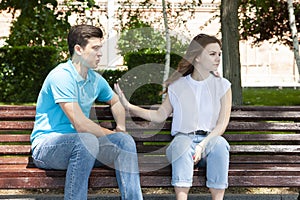 Couple sitting in park having relationship problems