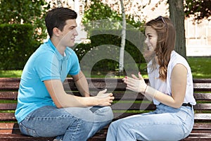 Couple sitting in park having relationship problems